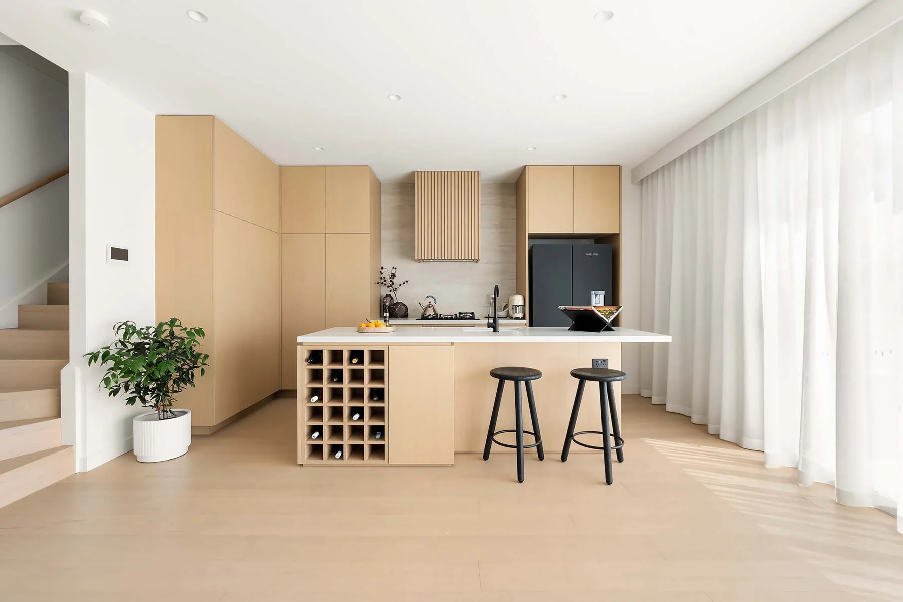 Floret kitchen cabinetry with an island and open wine storage